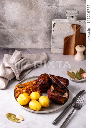 Grilled ribs with sauerkraut and potatoes 141216785