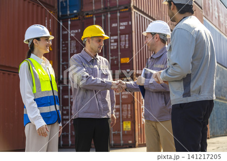 Group of engineers working and inspecting freight order in the container yard. This is a freight transportation and distribution warehouse. Group of engineers working and inspecting freight order in the container yard. This is a freight transportation and distribution warehouse. 141217205