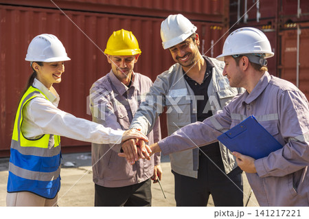 Group of engineers working and inspecting freight order in the container yard. This is a freight transportation and distribution warehouse. Group of engineers working and inspecting freight order in the container yard. This is a freight transportation and distribution warehouse. 141217221