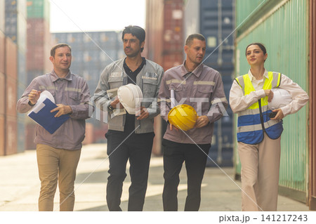 Group of engineers working and inspecting freight order in the container yard. This is a freight transportation and distribution warehouse. Group of engineers working and inspecting freight order in the container yard. This is a freight transportation and distribution warehouse. 141217243
