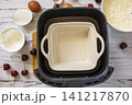 Step 5. The process of cooking cottage cheese casserole with cherries  in an air fryer, in kitchen gadget modern. Lifestyle trendy of new cooking. Healthy cooking with air fryer. 141217870