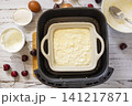 Step 6. The process of cooking cottage cheese casserole with cherries  in an air fryer, in kitchen gadget modern. Lifestyle trendy of new cooking. Healthy cooking with air fryer. 141217871