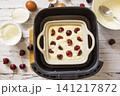 Step 7. The process of cooking cottage cheese casserole with cherries  in an air fryer, in kitchen gadget modern. Lifestyle trendy of new cooking. Healthy cooking with air fryer. 141217872