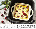 Homemade cottage cheese casserole with cherries in kitchen gadget modern air fryer on wooden background. perfect for breakfast or a snack. 141217875