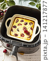 Homemade cottage cheese casserole with cherries in kitchen gadget modern air fryer on wooden background. perfect for breakfast or a snack. 141217877