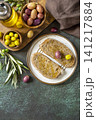 Italian ciabatta bread with olive oil on a stone surface. Delicious and healthy food. Vegan. Top view flat lay background. Copy space. 141217884