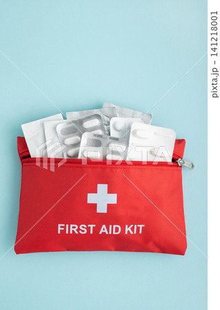 Red first aid kit bag with medicine blister packs 141218001