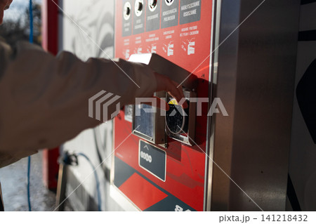 Hand pressing button on automated vending machine at manual carwash station. Hand pressing button on automated vending machine at manual carwash station. 141218432