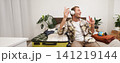 Portrait of handsome young man in wireless headphones, dancing and singing in wireless headphones, tourist getting ready for holiday, packing suitcase for business trip 141219144