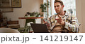 Portrait of man with serious face, sitting in cafe with laptop and smartphone, pointing at you with warning, scolding you, frowning with disapproval 141219147