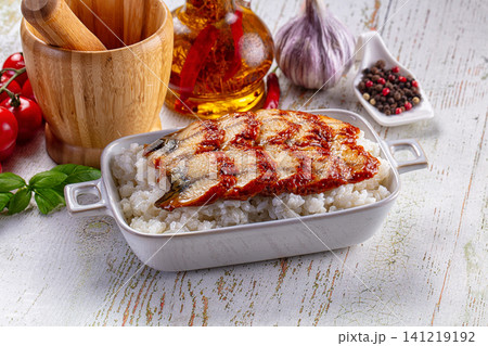 Grilled fish fillet over rice with herbs and spices on rustic table Grilled fish fillet over rice with herbs and spices on rustic table 141219192