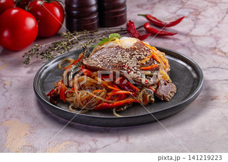 Beef and glass noodle stir fry with sesame seeds and red peppers 141219223