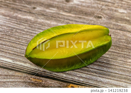 Fresh starfruit on rustic wooden surface Fresh starfruit on rustic wooden surface 141219238