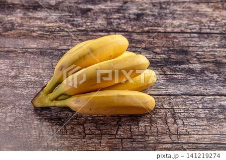 Fresh yellow bananas on rustic wooden surface 141219274