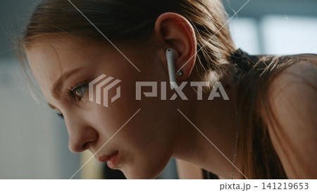 Exhausted Girl Gymnast Sitting with on Dressing Facility Bench Exhausted Girl Gymnast Sitting with on Dressing Facility Bench 141219653