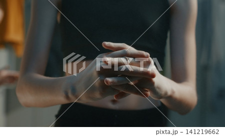 Teen Girl Rubbing Sports Magnesium on Palms Backstage Before Workout Teen Girl Rubbing Sports Magnesium on Palms Backstage Before Workout 141219662