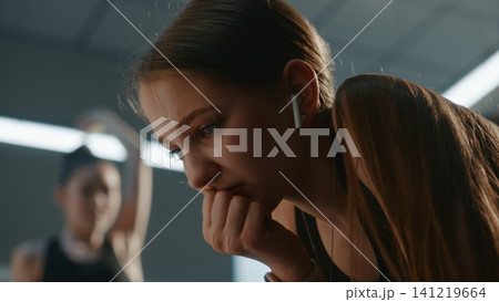 Upset Teenage Girl Listening to music to Calm Down inside Changing Room Upset Teenage Girl Listening to music to Calm Down inside Changing Room 141219664
