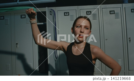 Exhausted Teen Pushes in Pain to Exercise Side Obliques and Arms With Fitness Band 141219668