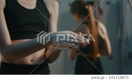 Focused Young Athlete Using Chalk inside Studio Dressing Room Focused Young Athlete Using Chalk inside Studio Dressing Room 141219673