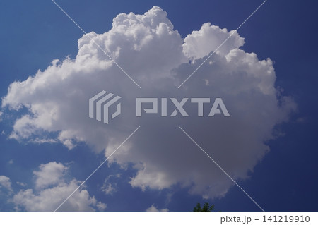 Photo of a large cloud with highlights and shadows on blue sky Blank for artworks 141219910