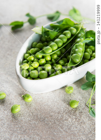 Fresh green peas in bowl representing healthy eating Fresh green peas in bowl representing healthy eating 141219999