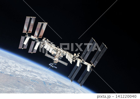 International Space Station floats above Earth's blue oceans and white clouds. Elements of this image furnished by NASA International Space Station floats above Earth's blue oceans and white clouds. Elements of this image furnished by NASA 141220040