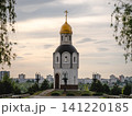 Volgograd, Russia - 05.23.2023: Serene historic church with golden dome nestled in vibrant green foliage, evoking peace and cultural heritage 141220185