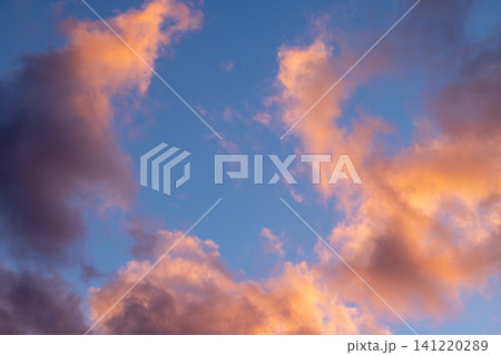 Golden hour clouds filling blue sky 141220289
