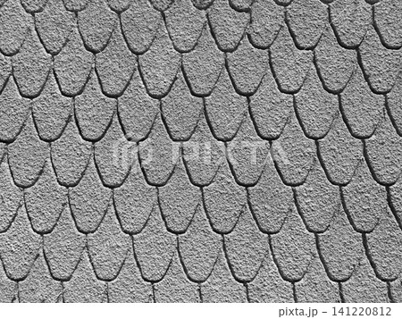 Monochrome grey stucco wall featuring an overlapping scallop pattern Monochrome grey stucco wall featuring an overlapping scallop pattern 141220812