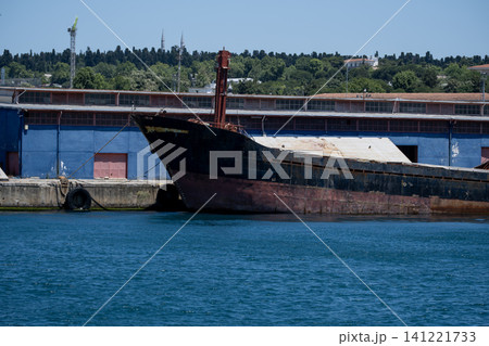 Old Rusty Cargo Ship Moored at the Harbor. Old Rusty Cargo Ship Moored at the Harbor. 141221733