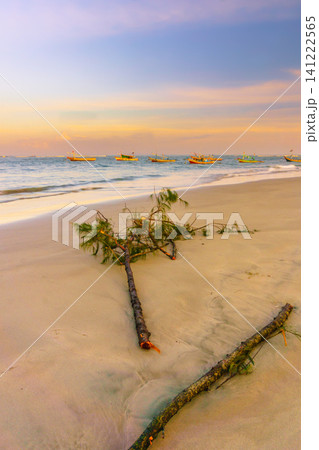 Sunset beach in Indonesia with golden waves and pristine white sand capturing tropical beauty and serene coastal atmosphere 141222565