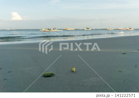 Sunset beach in Indonesia with golden waves and pristine white sand capturing tropical beauty and serene coastal atmosphere 141222571