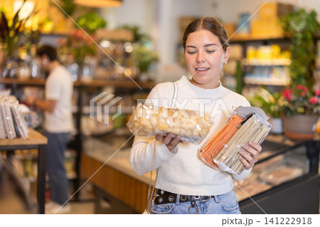 Store visitor, girl in sales area choosing pasta 141222918