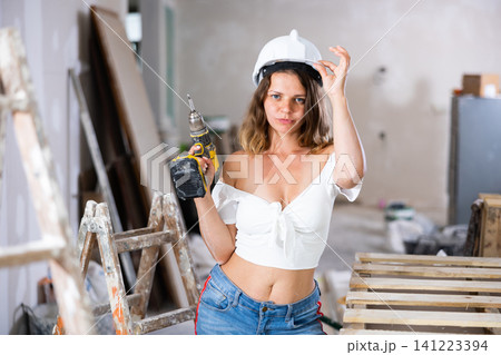Portrait of attractive woman with drill 141223394