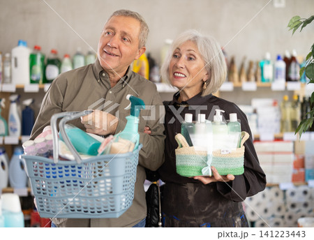 elderly couple chooses goods in a household chemicals store 141223443