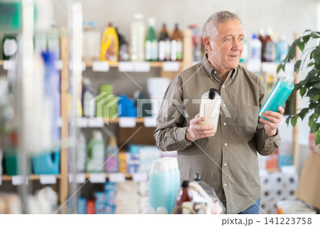 Elderly man choosing shampoo and shower gel 141223758