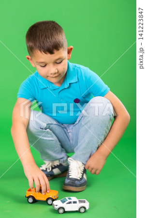 Boy in jeans with toy cars Boy in jeans with toy cars 141223847