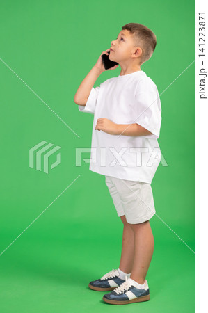 Preschooler boy is talking on phone Preschooler boy is talking on phone 141223871