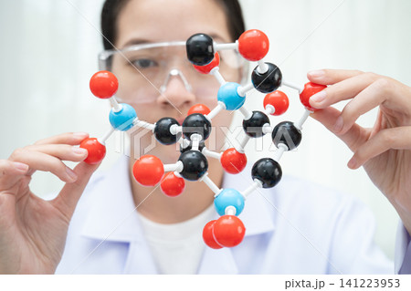 Scientist holding molecular model for chemical technology. Scientist holding molecular model for chemical technology. 141223953