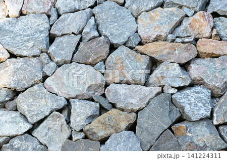 Closeup of natural crushed stones rough gray surfaces irregular shapes creating durable rock texture background for construction landscaping design Closeup of natural crushed stones rough gray surfaces irregular shapes creating durable rock texture background for construction landscaping design 141224311