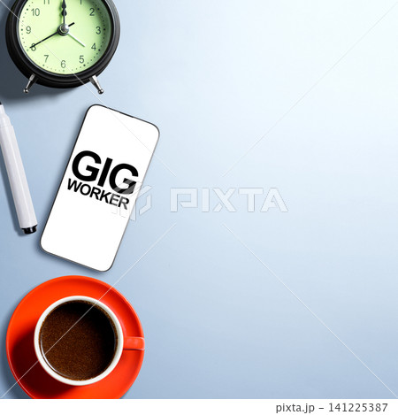 Flat lay composition of a smartphone showing Gig Worker text, a cup of coffee, marker, and an alarm clock on a light blue background with copy space Flat lay composition of a smartphone showing Gig Worker text, a cup of coffee, marker, and an alarm clock on a light blue background with copy space 141225387