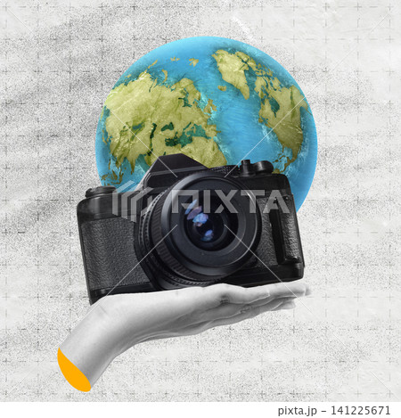 A creative digital collage featuring a hand holding a vintage black photo camera in front of the planet Earth globe. Perfect for travel, global photography, and environmental themes 141225671