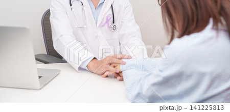 doctor holding patient hand to comfort and support with empathy. light purple ribbon for concept of All cancer, April Esophageal Cancer, November gastric and Stomach cancer, and World cancer day 141225813