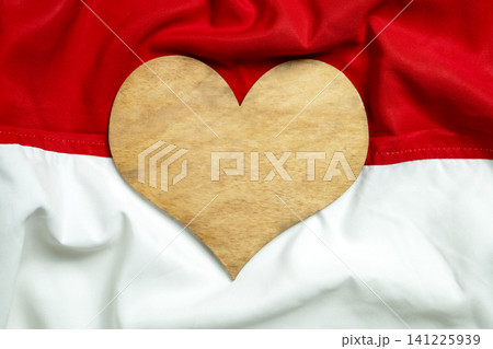 A wooden heart shape on the red and white Indonesian flag background, symbolizing patriotism, national pride, and love for Indonesia, ideal for Independence Day A wooden heart shape on the red and white Indonesian flag background, symbolizing patriotism, national pride, and love for Indonesia, ideal for Independence Day 141225939
