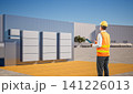 Asian engineer or technician with group of battery energy storage systems 141226013