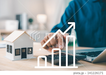 Real estate investment growth management and property asset invest concept shows businessman using calculator next to house model and laptop under rising financial chart Real estate investment growth management and property asset invest concept shows businessman using calculator next to house model and laptop under rising financial chart 141226171