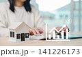 Residential property financial investment growth and profit chart, woman uses calculator with tablet in background planning wealth asset and finance for house buyer 141226173