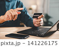 Secure online payment transaction credit card digital banking verification process involves person using laptop with smartphone for internet shopping, or performing electronic money transfer 141226175