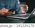 Man uses smartphone, digital, display, cyber, security, online, shopping, protection while paying with credit card on laptop, completing safe mobile payment, ensuring secure internet networking 141226176