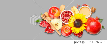 Fresh fruits including apples and pomegranates arranged with honey 141226328